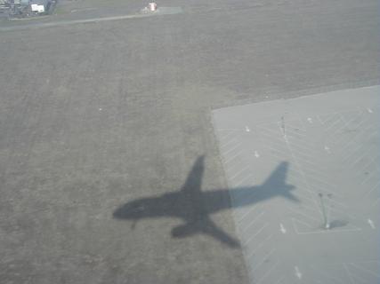 Shadow of the plane on the ground<br>Location: <a href="https://www.google.com/maps/search/?api=1&query=33.93847,-118.37352" target="_new">Over California</a>